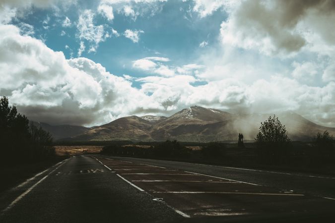 Road and mountain peak against blue sky