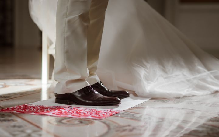 Delicate details of the wedding celebration. Newlyweds hold hands.