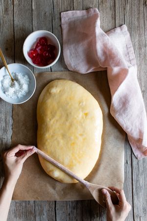 Faceless cook preparing Spanish pie coca San Juan