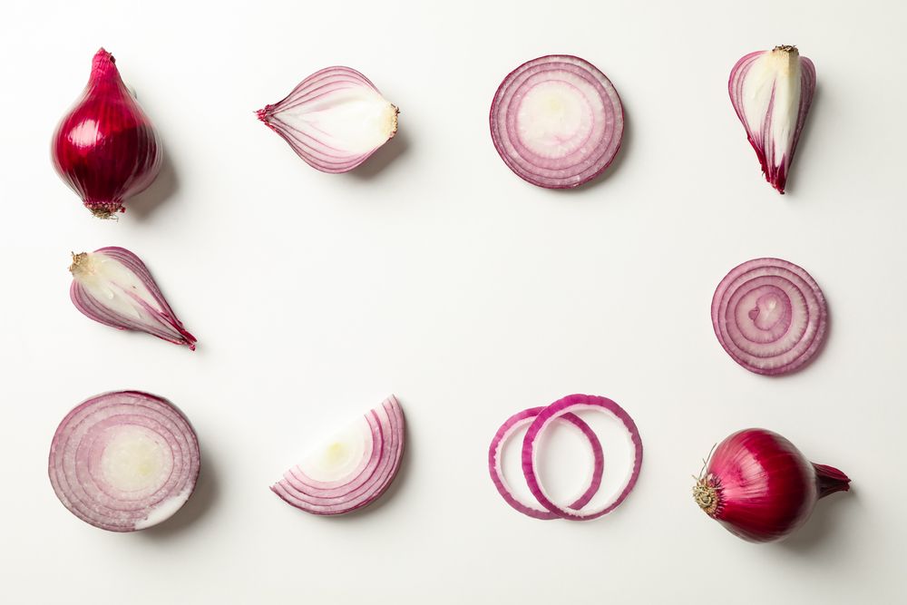 Flat lay composition with red onion on neutral background