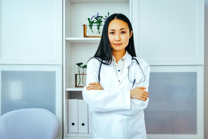 Confident Asian woman doctor at work