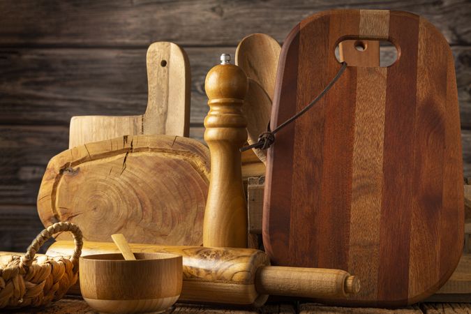 Wooden kitchen utensils on rustic background.