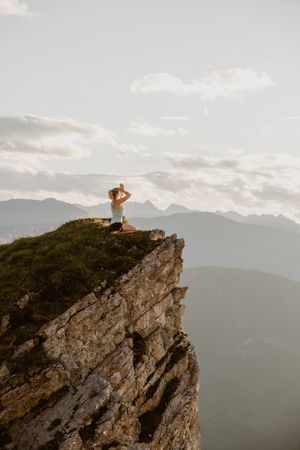 Woman meditating in mountain