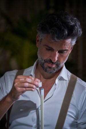 Mature male applying chalk on tip of cue