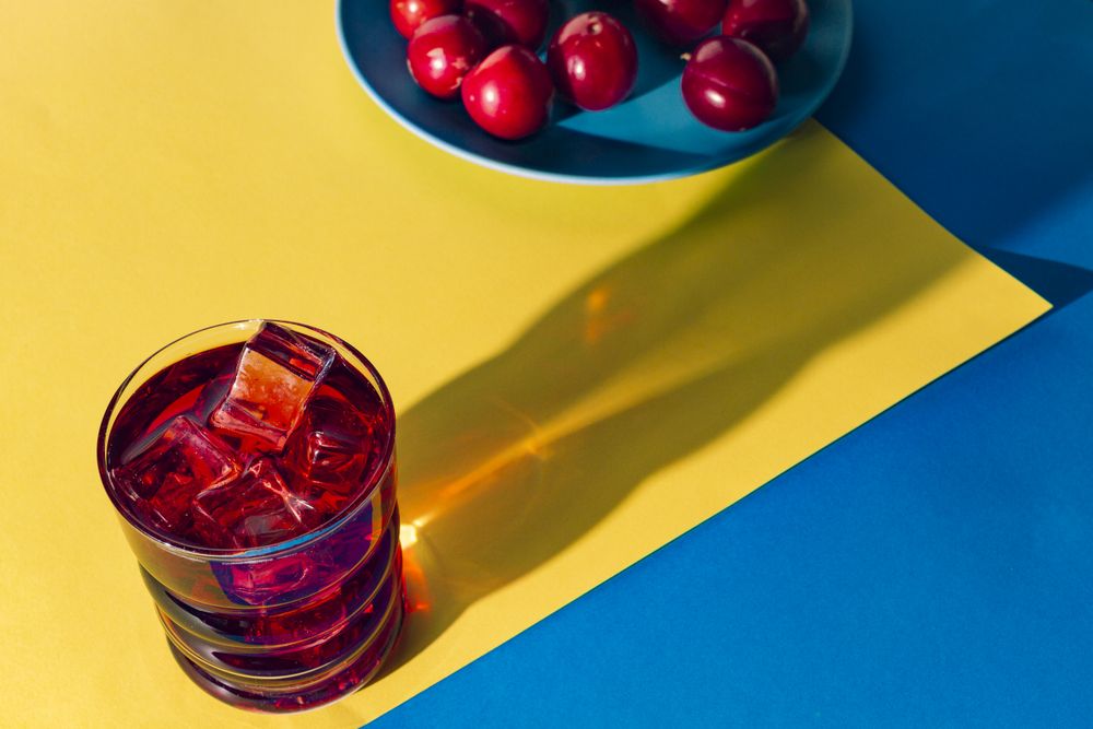 Red drink near fresh fruits