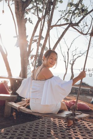 Young woman sitting on swing