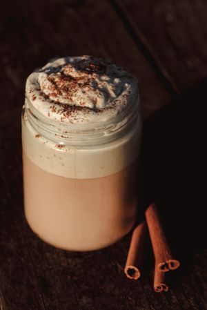 Cinnamon near coffee on table