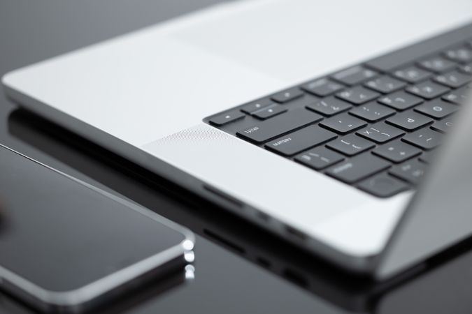 Laptop And iPhone On Desk