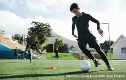 Soccer player training in soccer field 0WGQr0