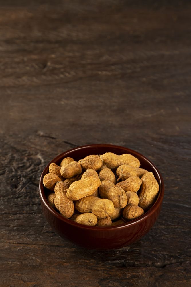 Bowl full of roasted peanuts.