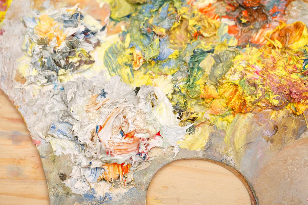 Painter palette with mixed light paints