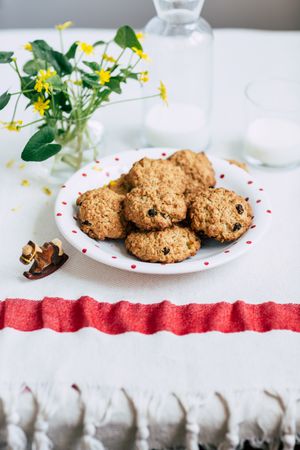 Cookies and milk near flowers
