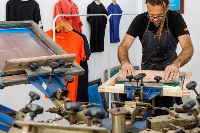Artist printing screen in workshop