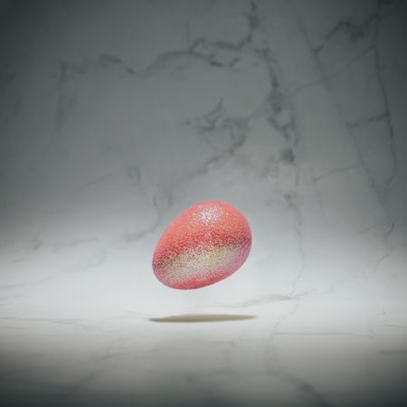 Pink glitter egg on marble background