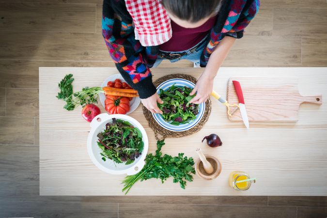 Woman preparing vegetable salad