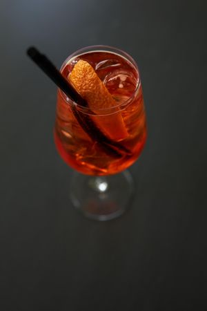 Orange cocktail with garnish and straw