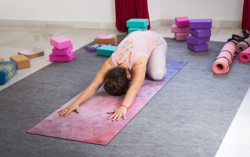 Young woman doing yoga indoors