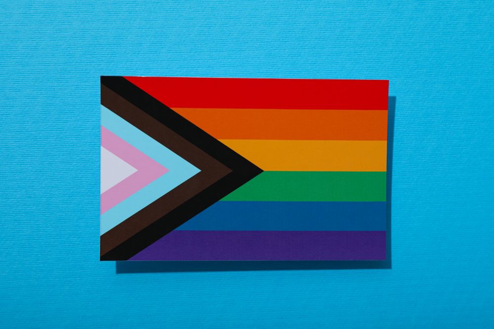 Pride parade concept, festive colorful symbols on blue background.