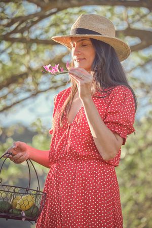Young woman smelling flower in garden