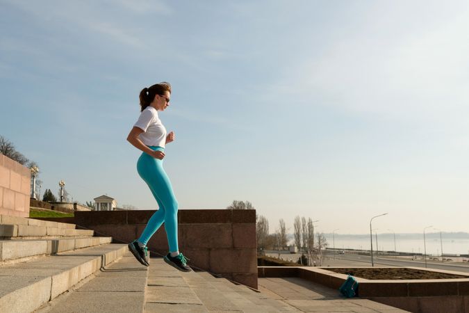 Young woman jogging on city streets