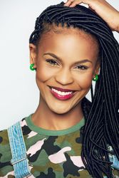 Portrait of confident woman smiling with her hands to her hair
