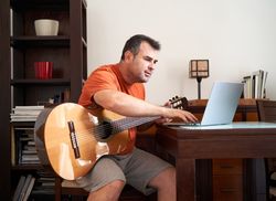 a man in online guitar lessons