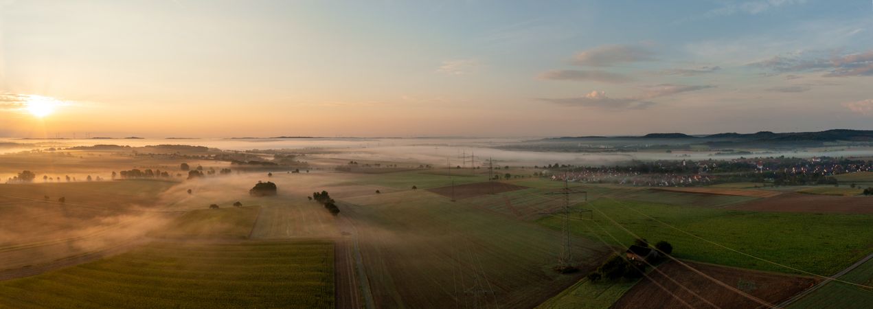 Golden hour drone photography of foggy agricultural landscapes in the morning