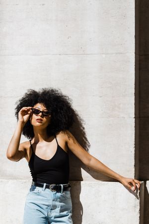 Cheerful Black female in dark sunglasses