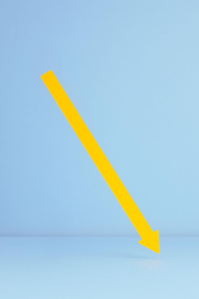 Yellow paper arrow over blue background