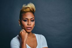 Surprised Black woman with short blonde hair with hand to her chin