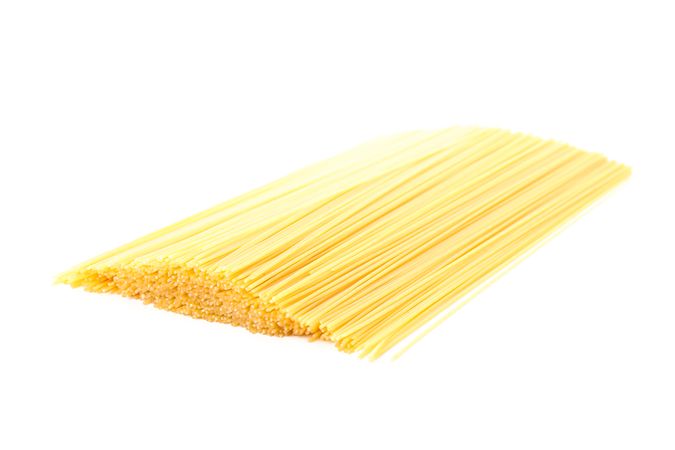 Pasta isolated on bright background, closeup. Dry uncooked whole pasta