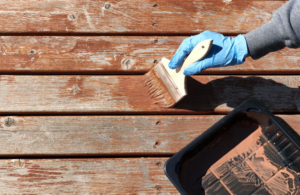 Staining home outdoor deck for weathered cedar planks