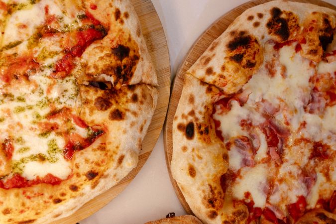Overhead portrait of several pizzas