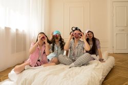 Girls and mom pretend to use curlers as binoculars.