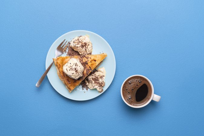 Apple pie with ice cream and cup of coffee