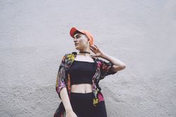 Woman in orange cap looking away