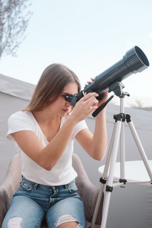 female using astronomical telescope