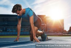 Young male athlete at starting block on running track - Free Photo