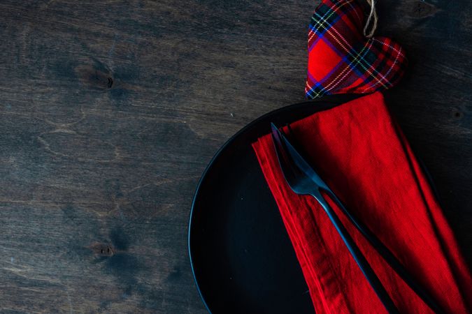Valentine's table setting with red napkin and tartan heart 