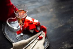 Champagne on trey with gift & silverware with copy space