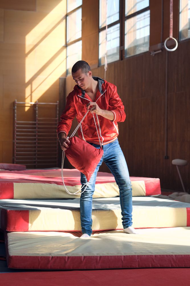 Young sports gymnast arriving at the gym to train exercises, tak