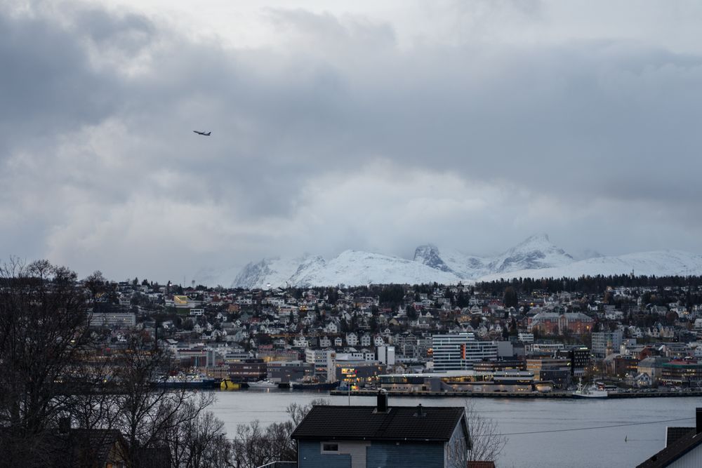 Wonderful cityscape against snowy highland in cold overcast weather