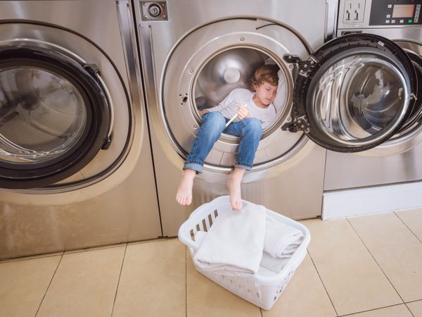 Boy sleeping in washing machine