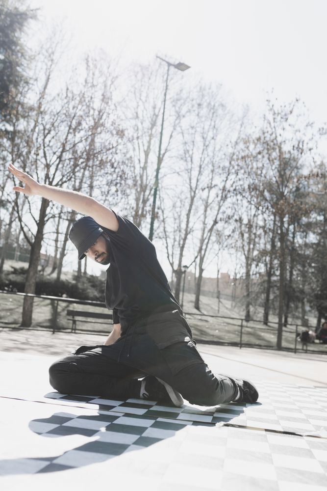 Man dancing break dance in park