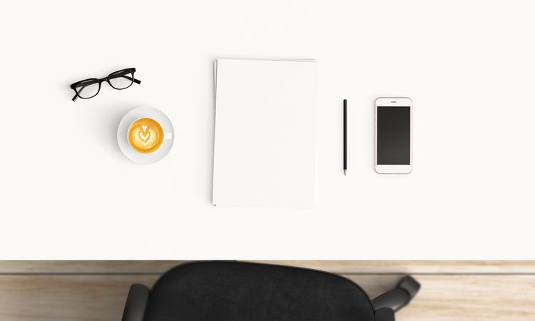 Modern workplace with coffee cup and smartphone or laptop copy space on office table background. Top view. Flat lay style