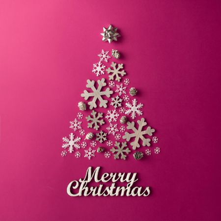 Christmas Tree made of snowflakes on pink background with “Merry Christmas”