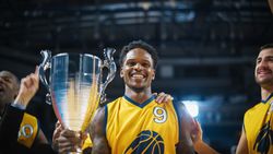 Happy Diverse Sports Team Victorious at Basketball Association Playoffs: Group of Players Celebrate the Victory with a Coach.
