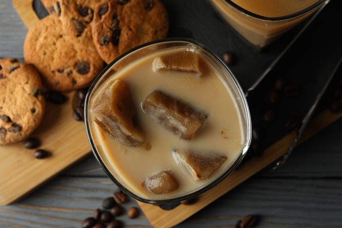 Composition with ice coffee and cookies on wooden background