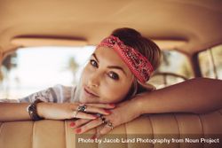 Female wearing bandana relaxing in a vintage car 4Oo9g4
