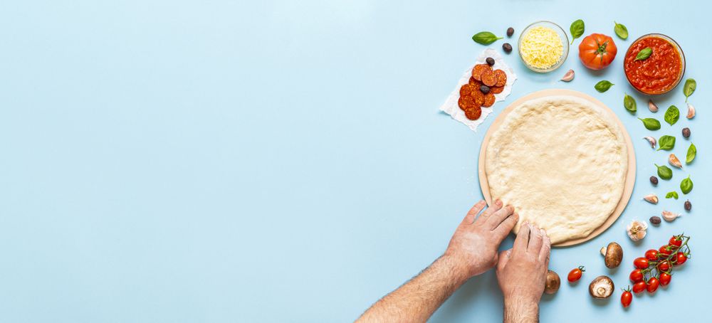 Preparing pizza dough on a baking stone
